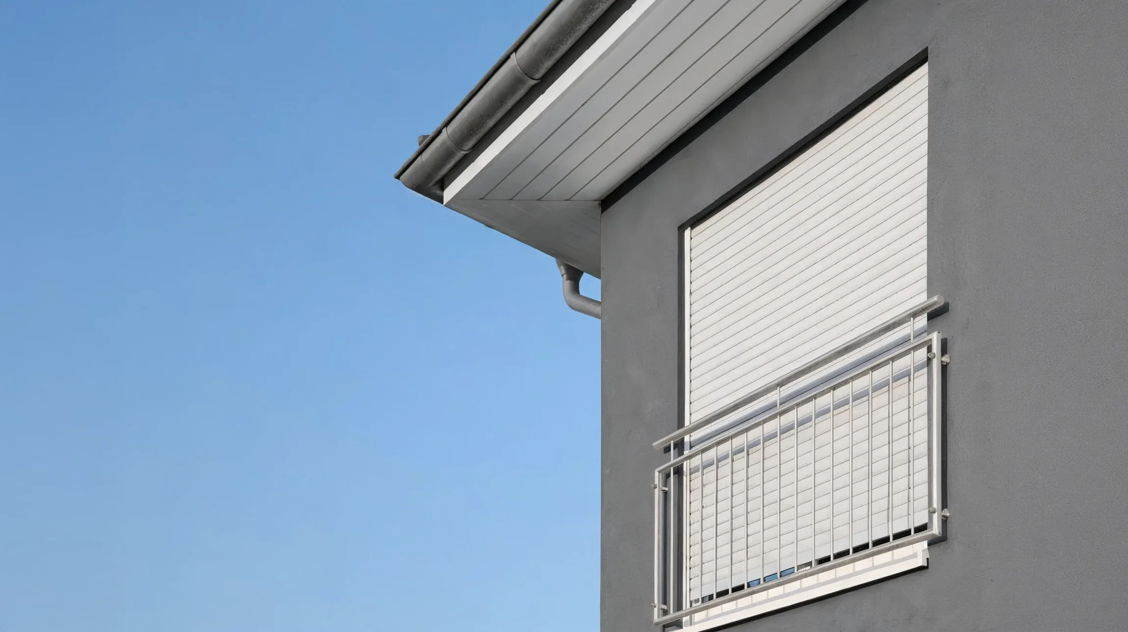 Façade d'immeuble résidentiel avec murs extérieurs bleu clair et encadrements de fenêtres blancs