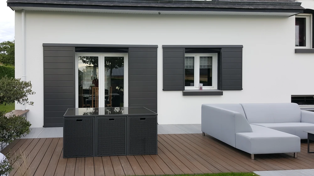 Portail coulissant moderne en aluminium gris anthracite installé devant une propriété résidentielle